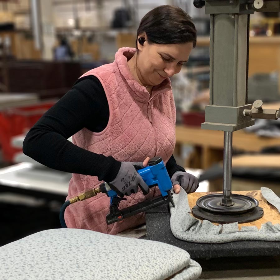 Images of KFI Studios employee upholstering seat